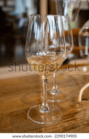 Tasting glass with cold brut Champagne sparkling wine in cellars of gran cru wine house in near Reims, wine tour in Champagne, France Royalty-Free Stock Photo #2290174905