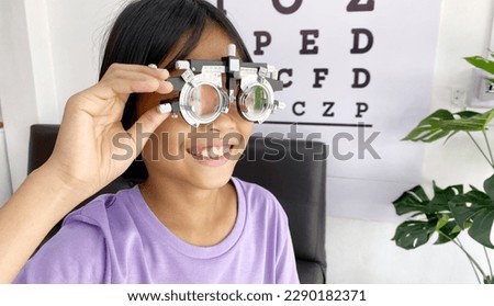Child wearing eyeglasses for medical eye test in clinic , eye exam, eye test concept, kid eye test Royalty-Free Stock Photo #2290182371