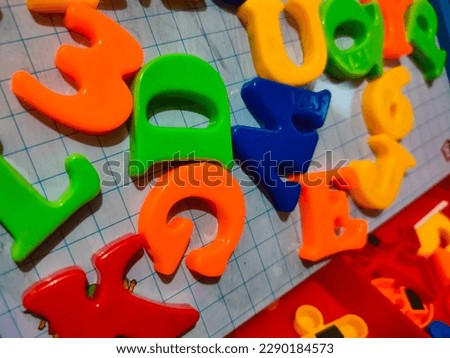 Colorful letters and numbers toys on a white board. Colorful alphabet