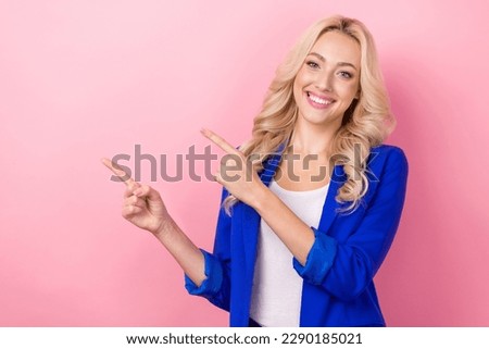 Portrait of cheerful satisfied promoter business manager direct fingers empty space like new office vacancy offer isolated on pink color background