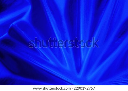 Blue abstract background of the relief pattern of glass surface. Close-up.