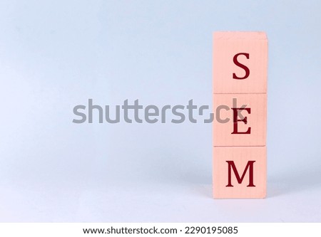 SEM on wooden cubes on blue background