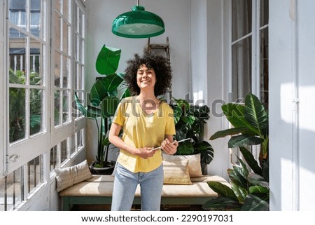 Beautiful latino young woman at home - Pretty south american adult female with curly hair  portrait, lifestyle and domestic life scene Royalty-Free Stock Photo #2290197031