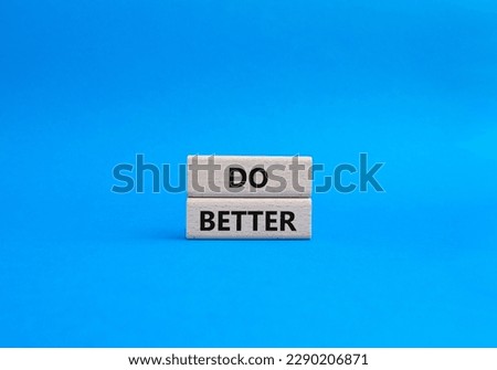 Do better symbol. Wooden blocks with words Do better. Beautiful blue background. Business and Do better concept. Copy space.