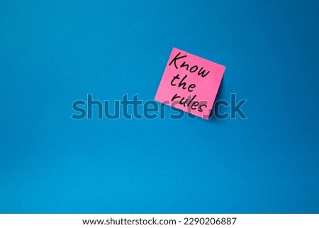 Know the rules symbol. Concept words Know the rules om pink steaky note. Beautiful blue background. Business and Know the rules concept. Copy space.