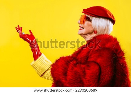 Happy and funny cool old lady with fashionable clothes portrait on colored background - Youthful grandmother with extravagant style, concepts about lifestyle, seniority and elderly people Royalty-Free Stock Photo #2290208689