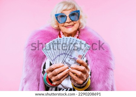 Happy and funny cool old lady with fashionable clothes portrait on colored background - Youthful grandmother with extravagant style, concepts about lifestyle, seniority and elderly people Royalty-Free Stock Photo #2290208691