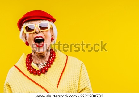 Happy and funny cool old lady with fashionable clothes portrait on colored background - Youthful grandmother with extravagant style, concepts about lifestyle, seniority and elderly people Royalty-Free Stock Photo #2290208733