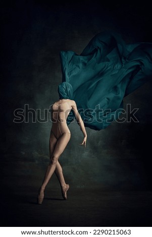 Gorgeous silhouette. Charming ballerina dancing graceful movement with silk fabric over dark green background. Art, motion, action, flexibility, inspiration concept. Beauty of contemporary dance