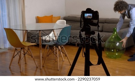 Real estate photographer taking pictures and videos  at house  in apartment living room with professional camera - selling home with real estate agency and home staging indoor home design  Royalty-Free Stock Photo #2290237059