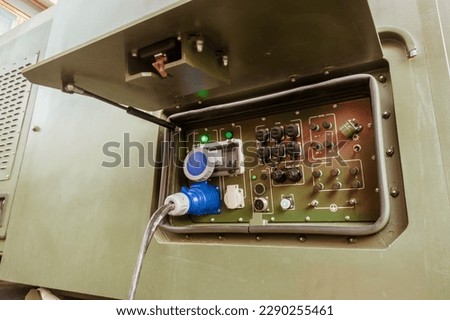 Power supply system in the field on military equipment. Royalty-Free Stock Photo #2290255461