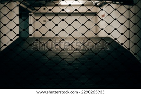 grid of a garage gate in the city at night