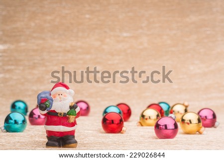Santa Claus and christmas balls on illuminated background