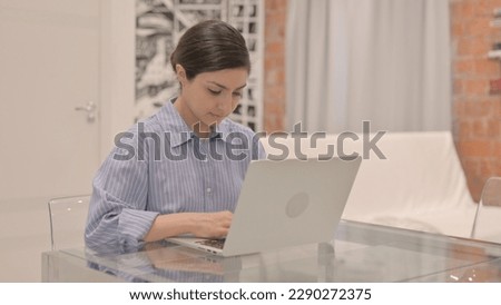 Busy Young Woman Working on Laptop