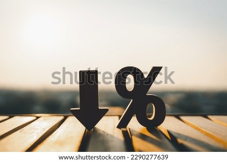 Percentage model and down arrow with evening sky Key concepts for success, methods, systems of raising or lowering Fed interest rates to correct inflation concepts. Royalty-Free Stock Photo #2290277639