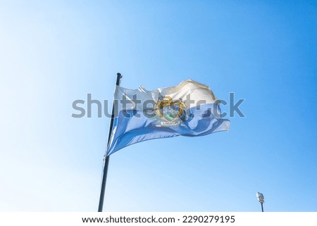 Flag of San Marino in front of blue sky
