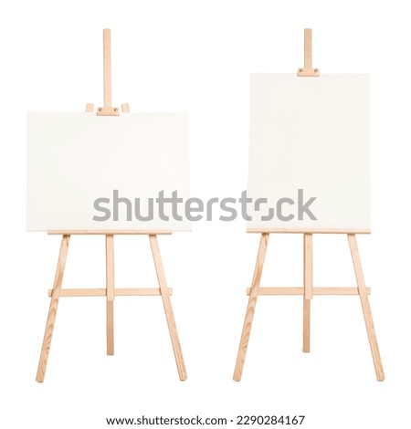 Wooden easel with different canvases isolated on white Royalty-Free Stock Photo #2290284167