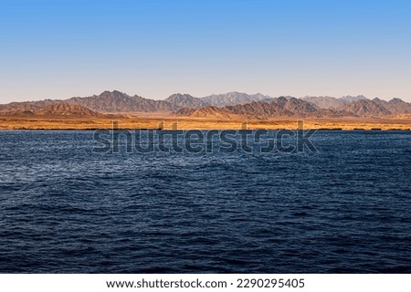 Beautiful view of the golden mountain coast from the azure sea. Red Sea, Egypt