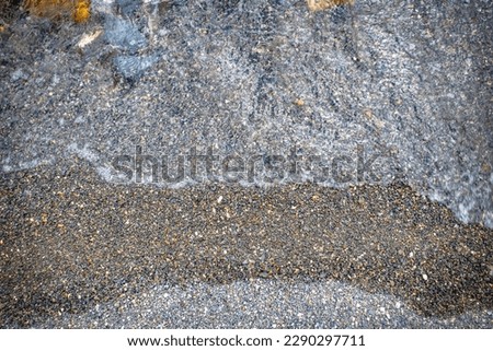 Close up water with stones background concept photo. Pebbles under water. The view from the top, nautical background. High quality picture for wallpaper