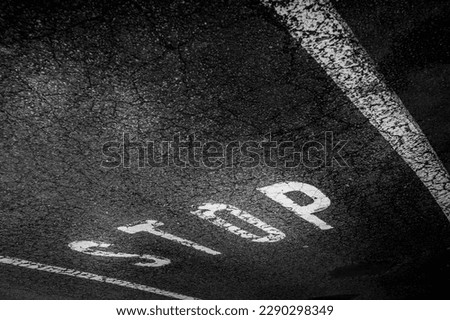 Stop sign on the asphalt road. black and white traffic signal.