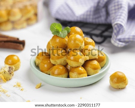 Nastar Cookies, Pineapple tarts or nanas tart are small, bite-size pastries filled or topped with pineapple jam, commonly found when Hari Raya or Eid Al Fitr or Lebaran. Selective focus
 Royalty-Free Stock Photo #2290311177