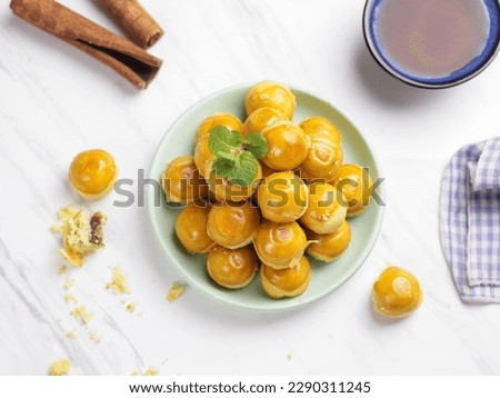 Nastar Cookies, Pineapple tarts or nanas tart are small, bite-size pastries filled or topped with pineapple jam, commonly found when Hari Raya or Eid Al Fitr or Lebaran. Selective focus
 Royalty-Free Stock Photo #2290311245
