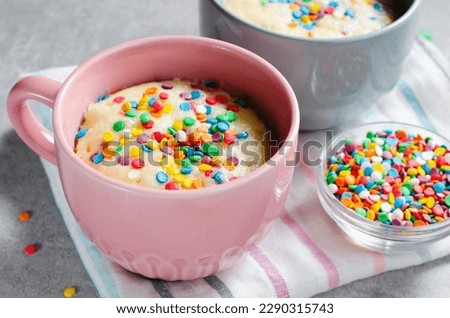 Funfetti Mug Cake, Homemade Cake Cooked in the Microwave on Bright Background Royalty-Free Stock Photo #2290315743