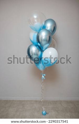 blue and chrome balloons in the room