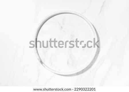 Beauty cosmetics product presentation flat lay mockup scene with white marble circle plate on white marble table with copy space. Trendy sunlight,  top view. Studio photography.