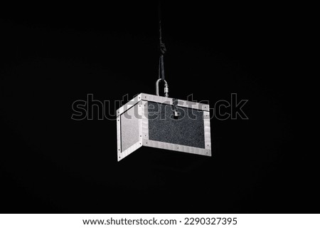 Black box hangs in a magic show, hanging from the ceiling
