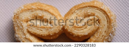 Top view of tasty puff pastry cookie with sugar sprinkle. Home cooking desserts and bakery products concept