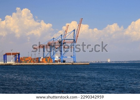Seaport Odessa, Ukraine. Export of grain from Ukraine. Cranes load ships, containers in sea port of Odesa. Grain agreement, delivery of goods, food, agricultural products Royalty-Free Stock Photo #2290342959