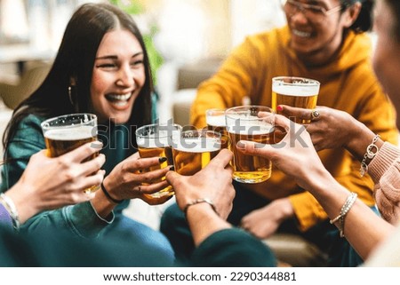 group of people cheering and drinking beer at bar pub table -Happy young friends enjoying happy hour at brewery restaurant-Youth culture-Life style food and beverage concept Royalty-Free Stock Photo #2290344881