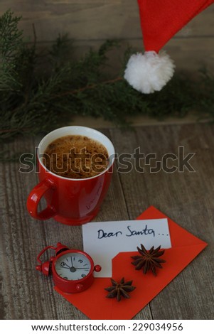 Cup of coffee with Christmas decorations and greeting card