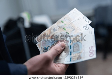 businessman holding 500 and 200 zlotys bills. A concept showing the Polish economy and finances. Economic situation in Poland