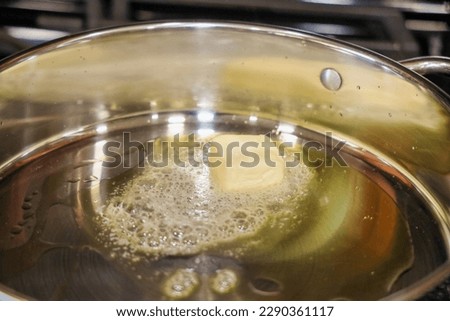 View of a pan with olive oil and butter melting.