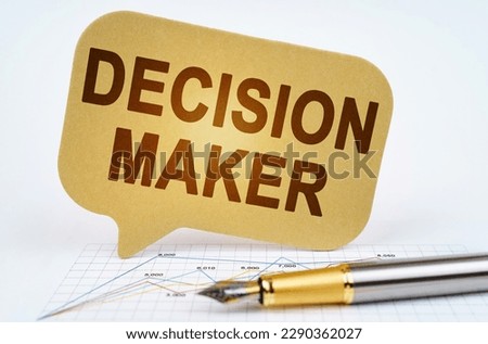 Business concept. On the business diagram is a pen and a sign with the inscription - DECISION MAKER