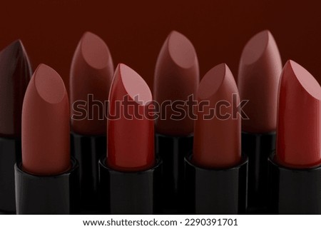 Various shades of red lipstick on a red background. Red Lipstick on a white background.