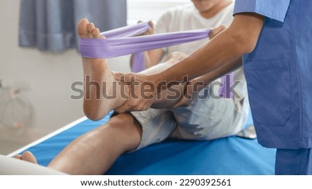 Athlete undergoing physiotherapy with a musculoskeletal specialist after sports and gym injuries. Royalty-Free Stock Photo #2290392561