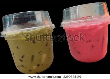 Green Tea and Pink Milk popular sweet drink in summer in Thailand, isolated on a black background.no focus