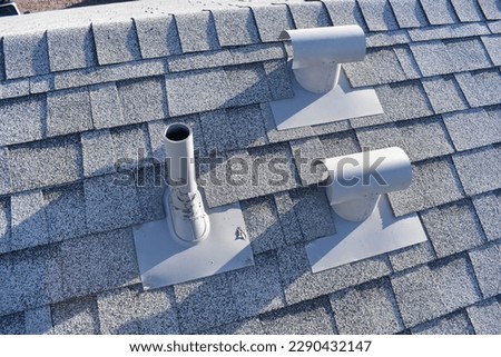 Roof Vent Penetrations on New Gray Shingled Roof  Royalty-Free Stock Photo #2290432147