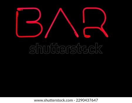 Neon glowing sign on black wall. electric luminous billboard, banner from red neon tubes. Neon sign shiny for Cocktail bar. empty copy space for inscription.