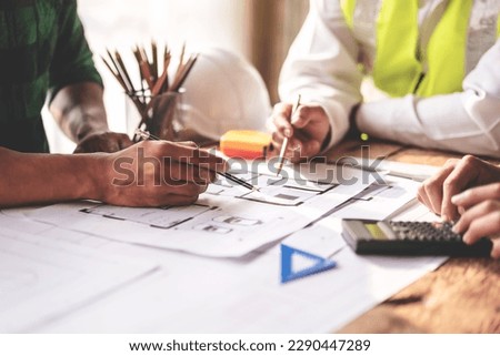 Construction and engineer structure concept of engineer working drawing on blueprint meeting for project working with partner on model building and engineering tools in working site.