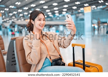 Happiness asian woman take selfie photo in airport terminal, female using smartphone take photo, Tourist journey trip concept.