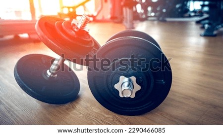 dumbbells in the gym on the floor, the concept of proper nutrition and fitness, a place for the inscription