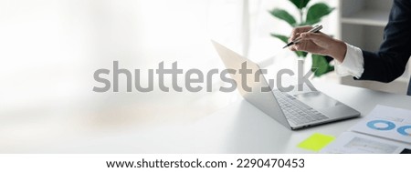 Person pointing at laptop screen, businessman sitting at company, looking at financial information on laptop summarized by the finance department. Concept of financial management. Royalty-Free Stock Photo #2290470453