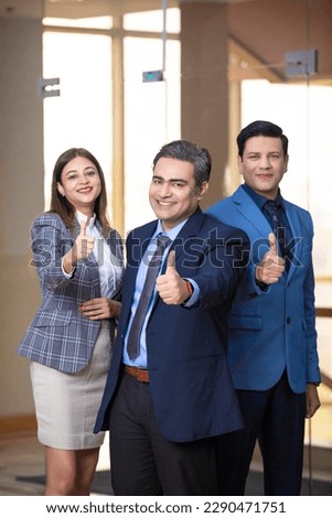Indian business people showing thumps up at office. Royalty-Free Stock Photo #2290471751