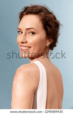 Portrait of real smiling woman  with white scrub on the shoulder  Royalty-Free Stock Photo #2290489435