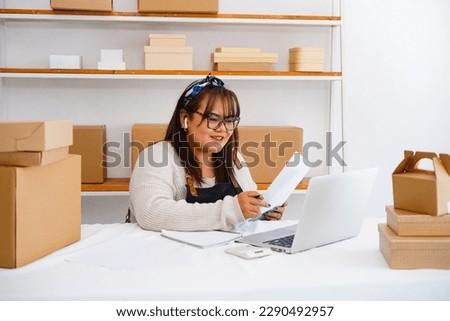 Photo of asian woman enterpreneur wear headset look at laptop talk to tutor use videoconference, heap of textbooks on table. Digital online educational course, videocall event concept Royalty-Free Stock Photo #2290492957