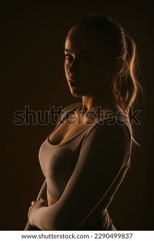 Close up of a pretty girl with ponytail posing at the studio